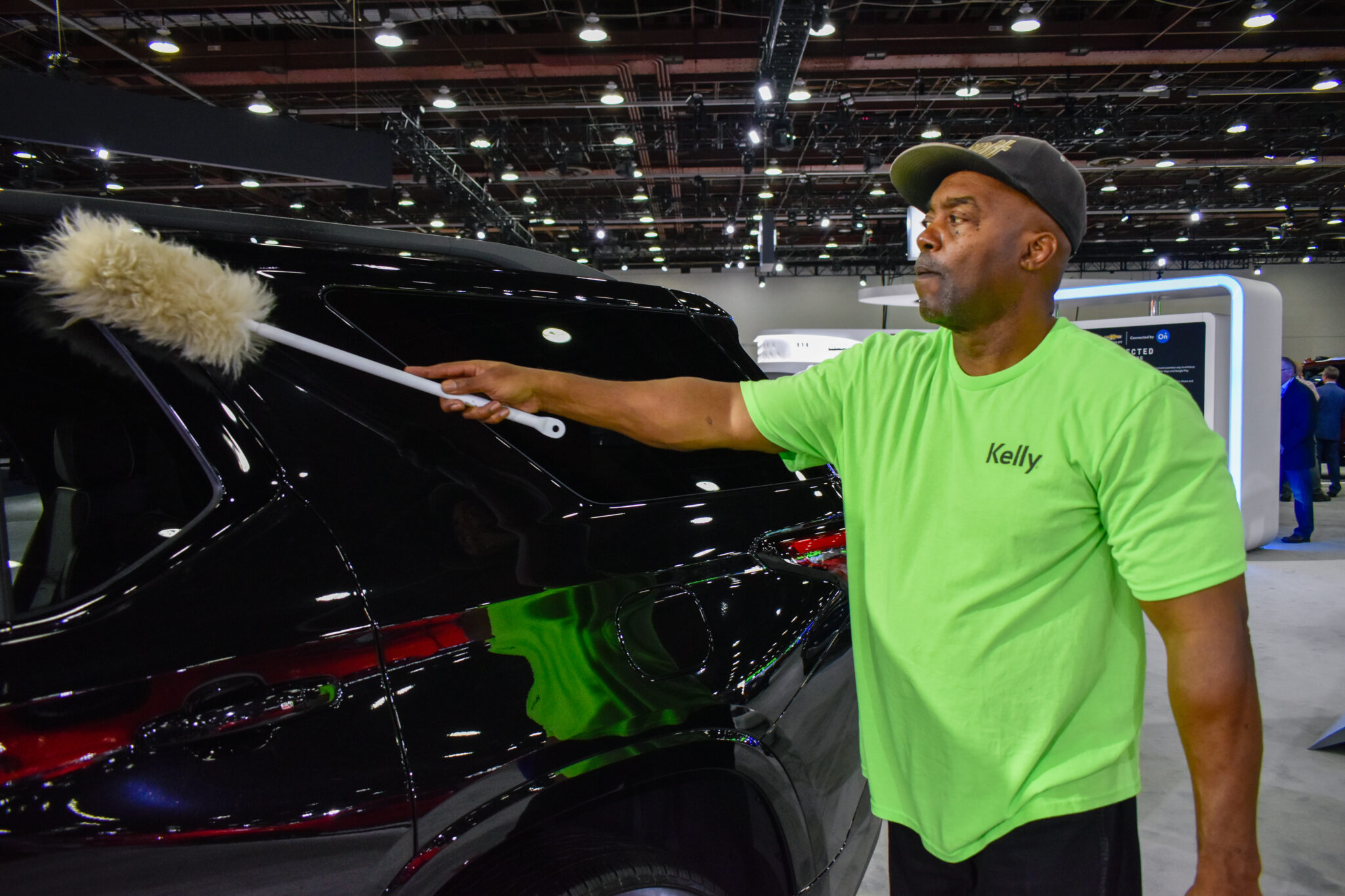 Staff members keep vehicles clean at the North American International Auto Show in Detroit on Sept. 14, 2022. 